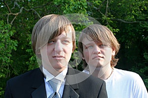 Serious Brothers In Tux And T-Shirt