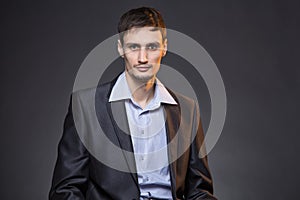 Serious brunette businessman in jacket