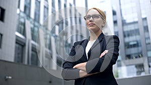 Serious business lady smiling, arms crossed, professionalism and experience