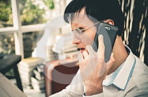 Serious Business man making call on his mobile phone