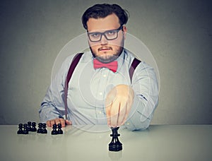 Serious business man playing chess game