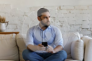Serious business man using online app on mobile phone