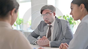 Serious Business People having Conversation in office