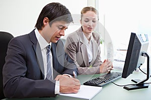 Serious business people working with a computer