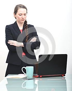 Serious business woman looking at computer