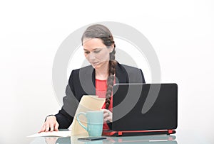 Serious business woman looking at document in files