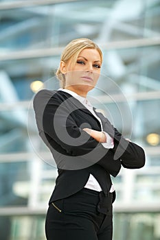 Serious business woman standing outdoors