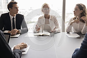 Serious business woman talk to colleagues on meeting