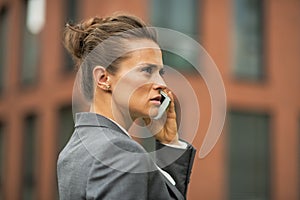 Serious business woman talking cell phone