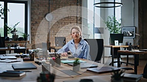 Serious business woman thinking at new startup sitting empty coworking office.