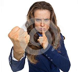 Serious business woman threatening with fist