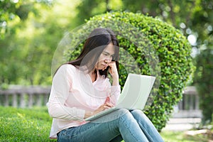 Serious business woman work hard with serious problem in a public park