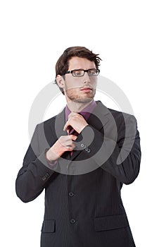 Serious businessman checking his tie