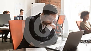 Serious businessman employee using laptop, working on difficult project