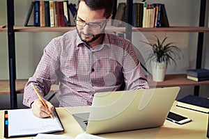 Serious businessman with glasses working at the office