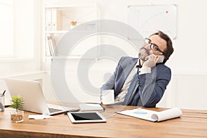 Serious businessman having phone talk