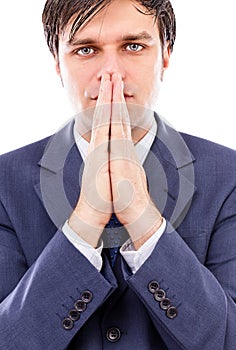Serious businessman holding both hands in front of his mouth