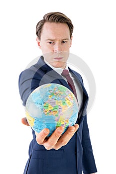 Serious businessman holding terrestrial globe