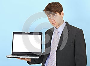 Serious businessman holds on hand laptop