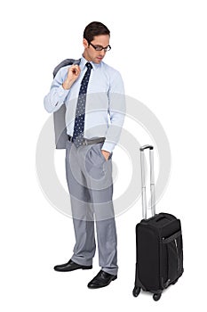 Serious businessman looking at his luggage