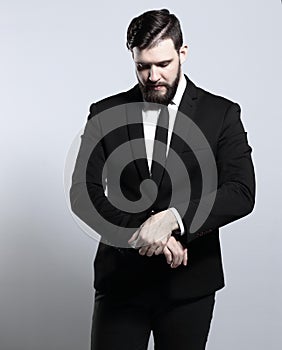 Serious businessman looking at his watch. on white background