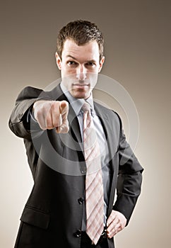 Serious businessman pointing accusing finger photo