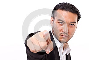 Serious businessman pointing at you