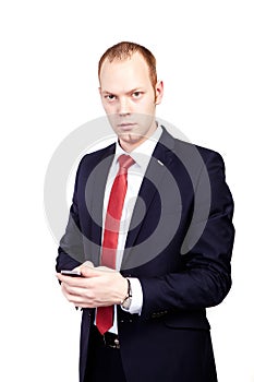Serious businessman reading text message on smart phone against