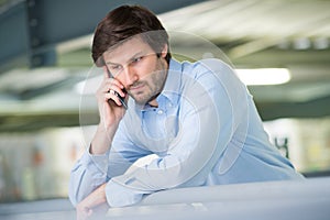 serious businessman receiving telephone call photo
