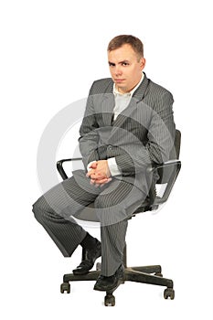 Serious businessman sits on chair