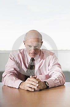 Serious Businessman Sitting At Desk