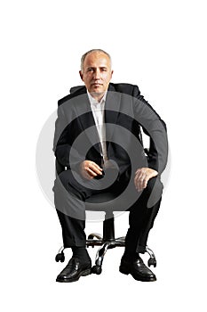 Serious businessman sitting on office chair