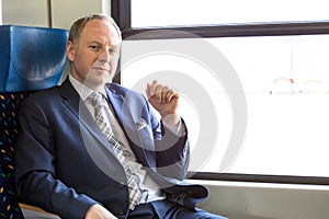 Serious businessman sitting in a train