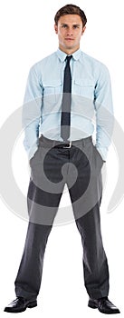 Serious businessman standing with hands in pockets