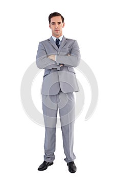 Serious businessman standing with his arms crossed