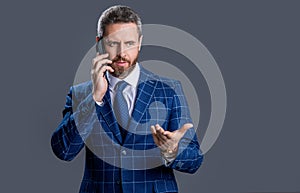 serious businessman talk on phone isolated on grey background. businessman having phone talk