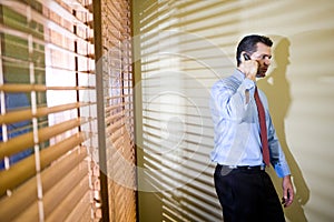 Serious businessman talking on mobile phone