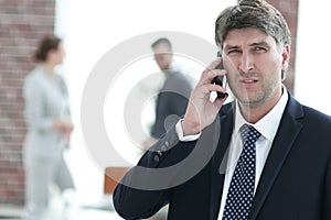 Serious businessman talking on the phone.