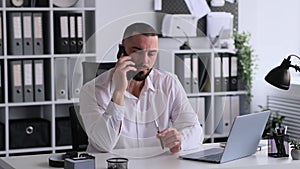 Serious Businessman Talking Phone Working In Office