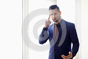 Serious businessman talking on telephone