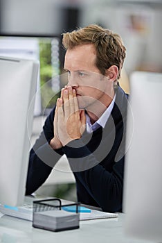 Serious, businessman and thinking at desk with computer and stress for research or analysis of company project. Male