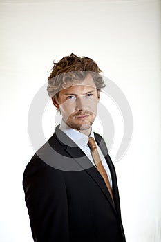 Serious businessman turning to look at camera
