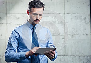 Serious businessman using tablet computer