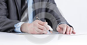 Serious businessman working with documents sitting at a Desk.