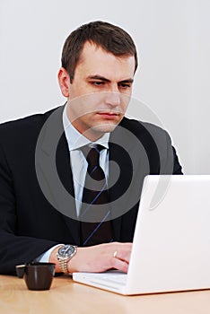 Serious businessman working on lap-top