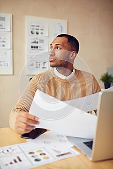 Serious Businessman Working Office. Guy Holding Documents at Computer Table