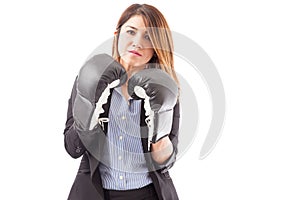 Serious businesswoman with boxing gloves