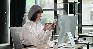 Serious Businesswoman Browsing Phone During Work Hours