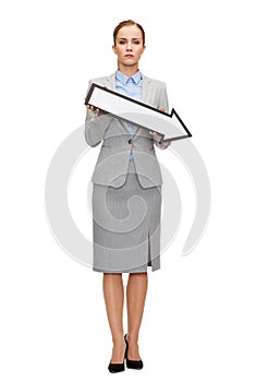 Serious businesswoman with direction arrow sign