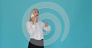 Serious Businesswoman Having a Phone Call on Blue Background